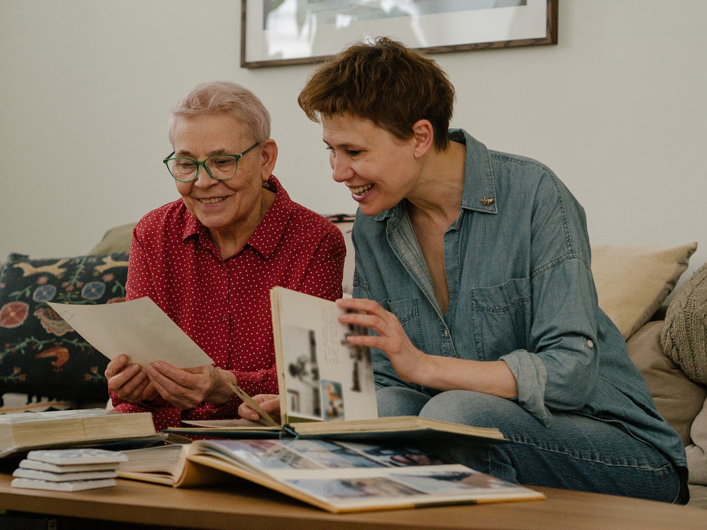 elderly mother with her daughter looking through family albums, Russia by Aks Huckleberry on 500px.com