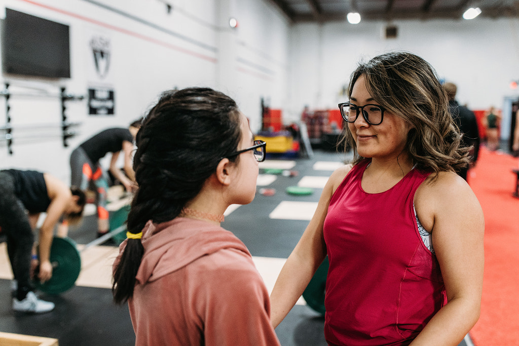 Asian female weightlifter showing daughter how to lift, Sharlene by Winnie Bruce on 500px.com