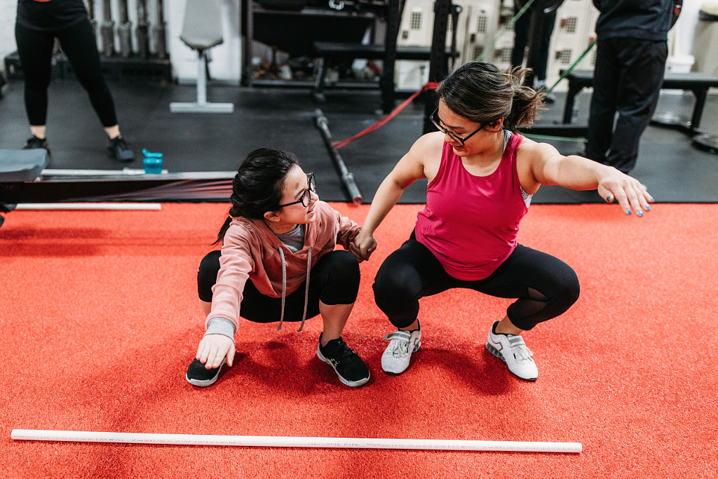 Asian female weightlifter showing daughter how to lift, Sharlene by Winnie Bruce on 500px.com