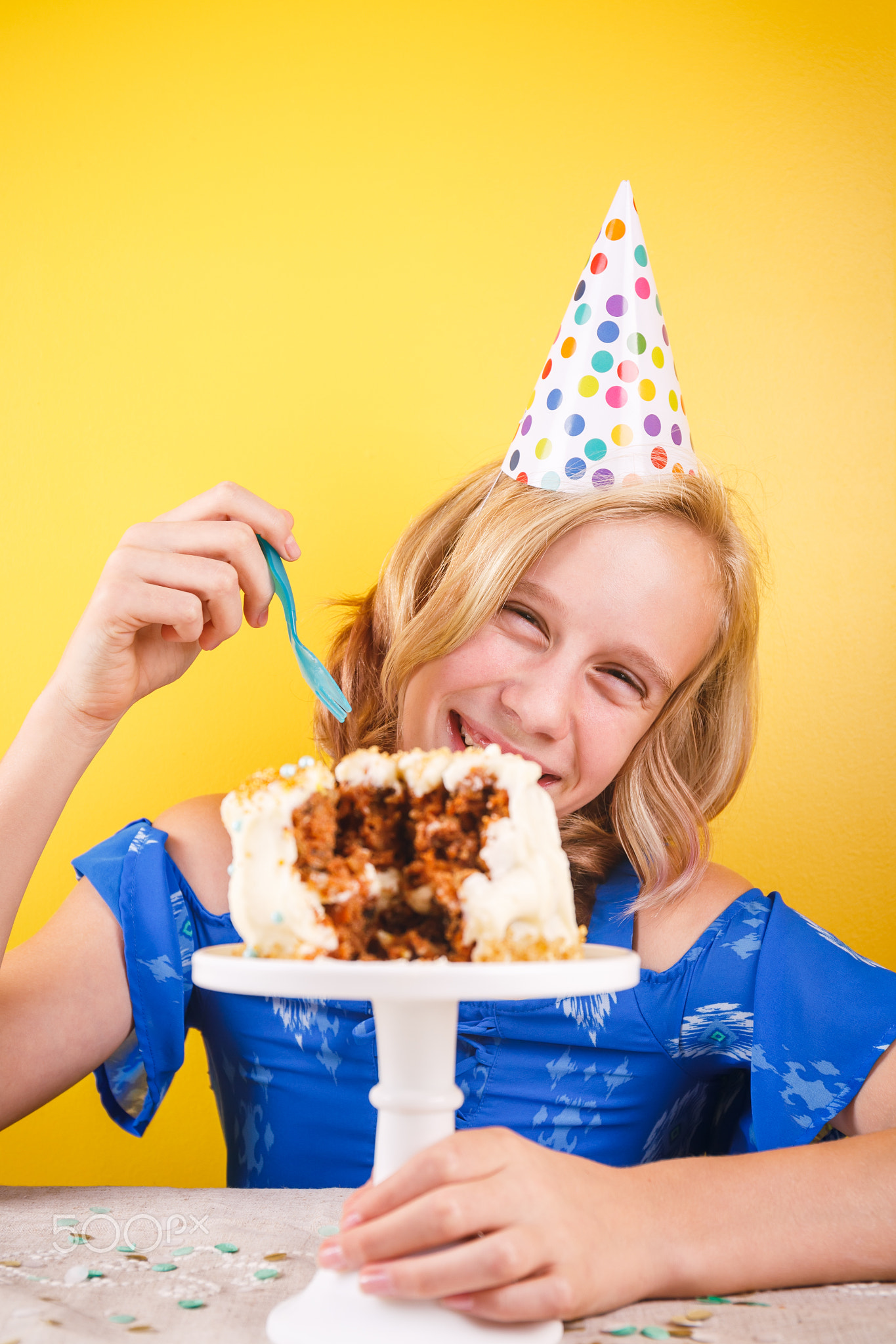 Teenage girl enjoying herself after ruining birthday cake. One person