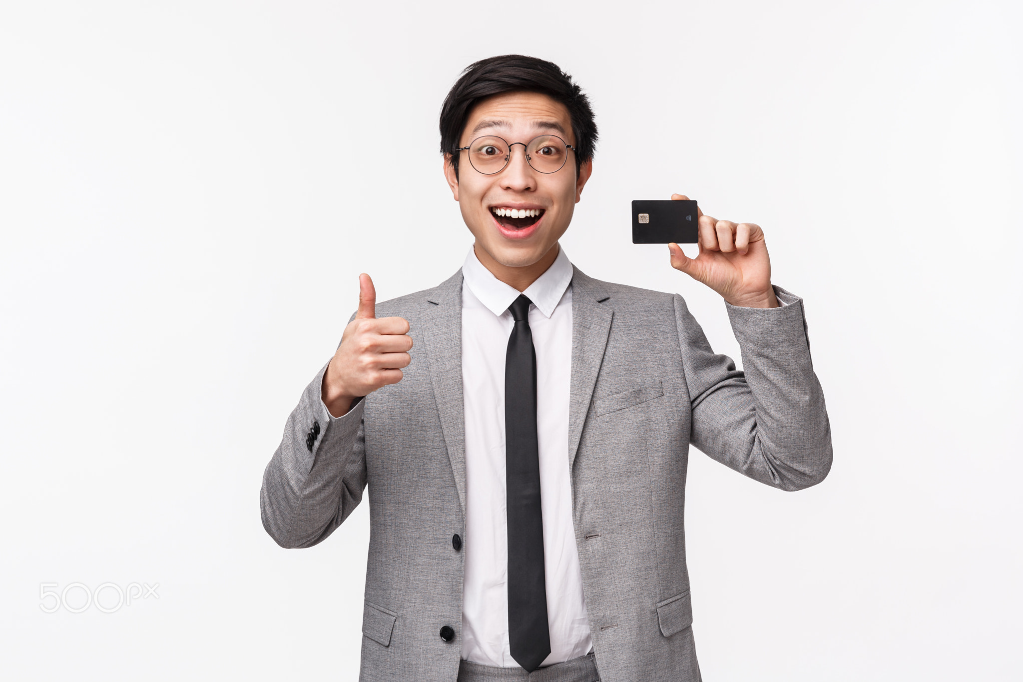 Waist-up portrait of excited, happy smiling asian male office worker