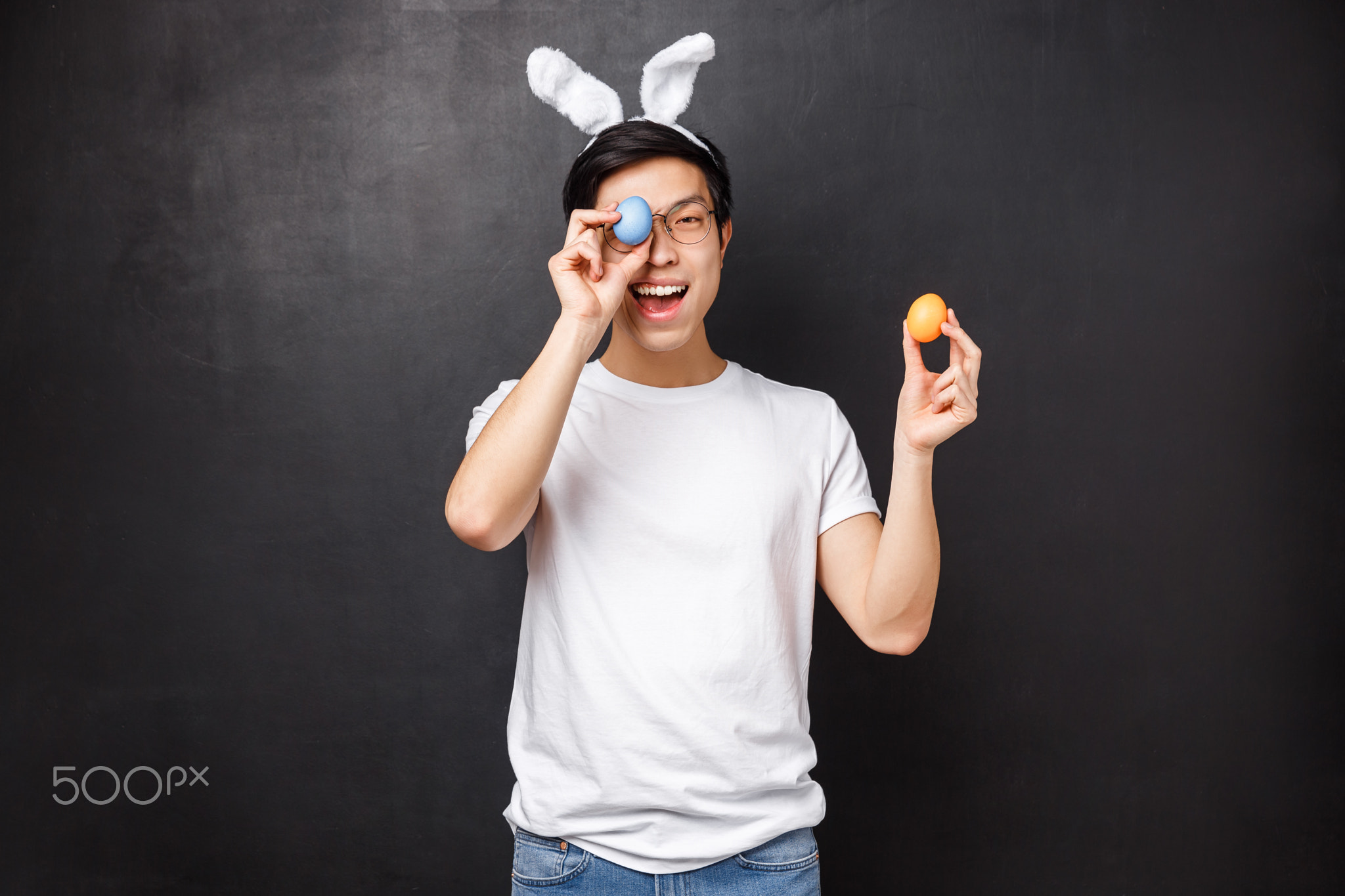 Holidays, party and Easter concept. Amused cute asian silly guy in