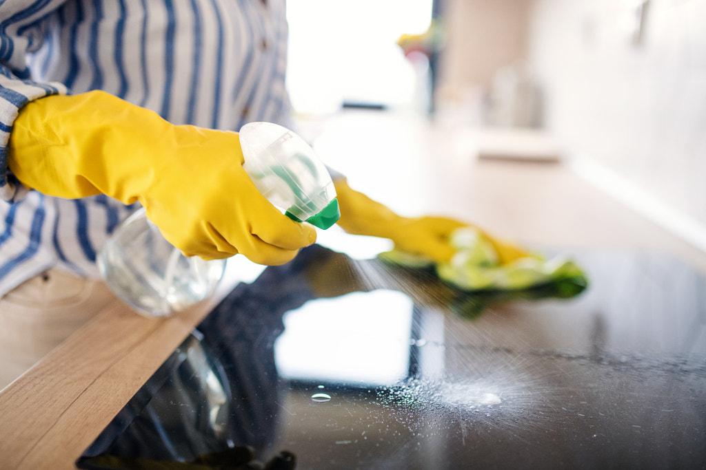 Unrecognizable senior woman cleaning kitchen counter indoors at home. by Jozef Polc on 500px.com