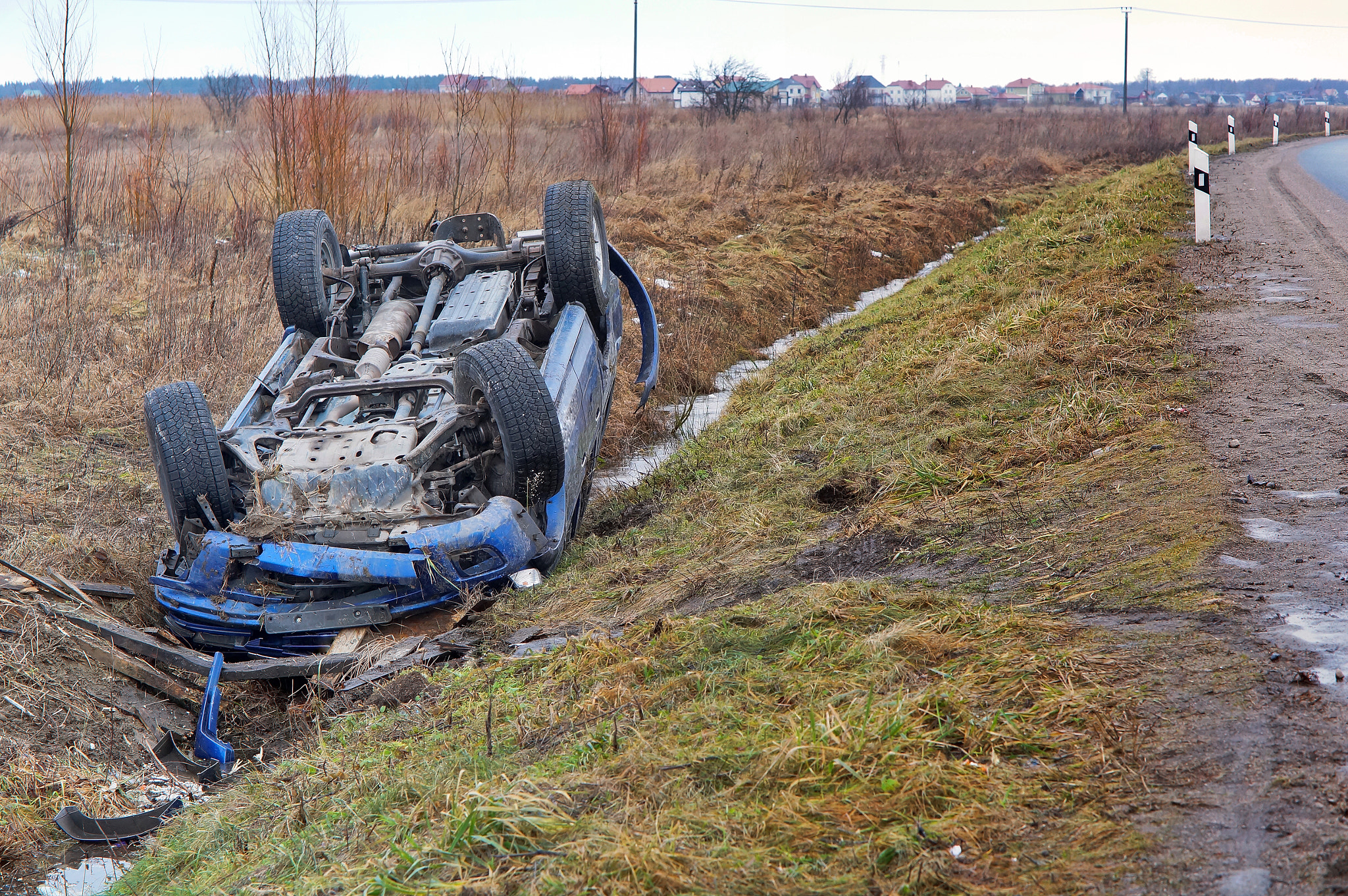 car crash, blue car overturned on the road transport traffic accident