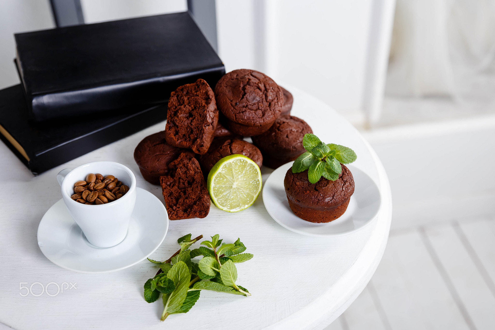 Chocolate cupcakes with coffee beans on a white wooden table