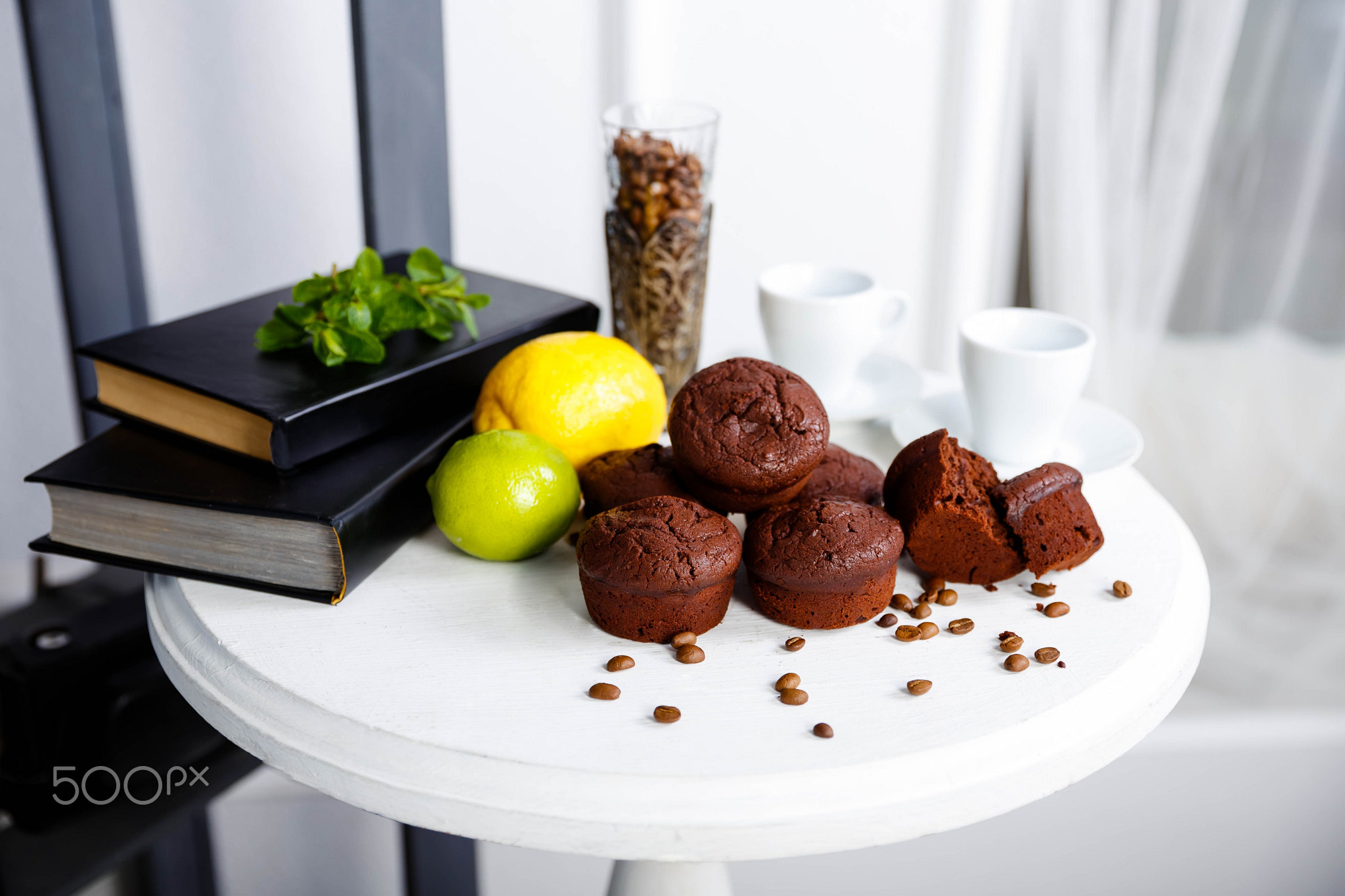 Chocolate cupcakes with coffee beans on a white wooden table