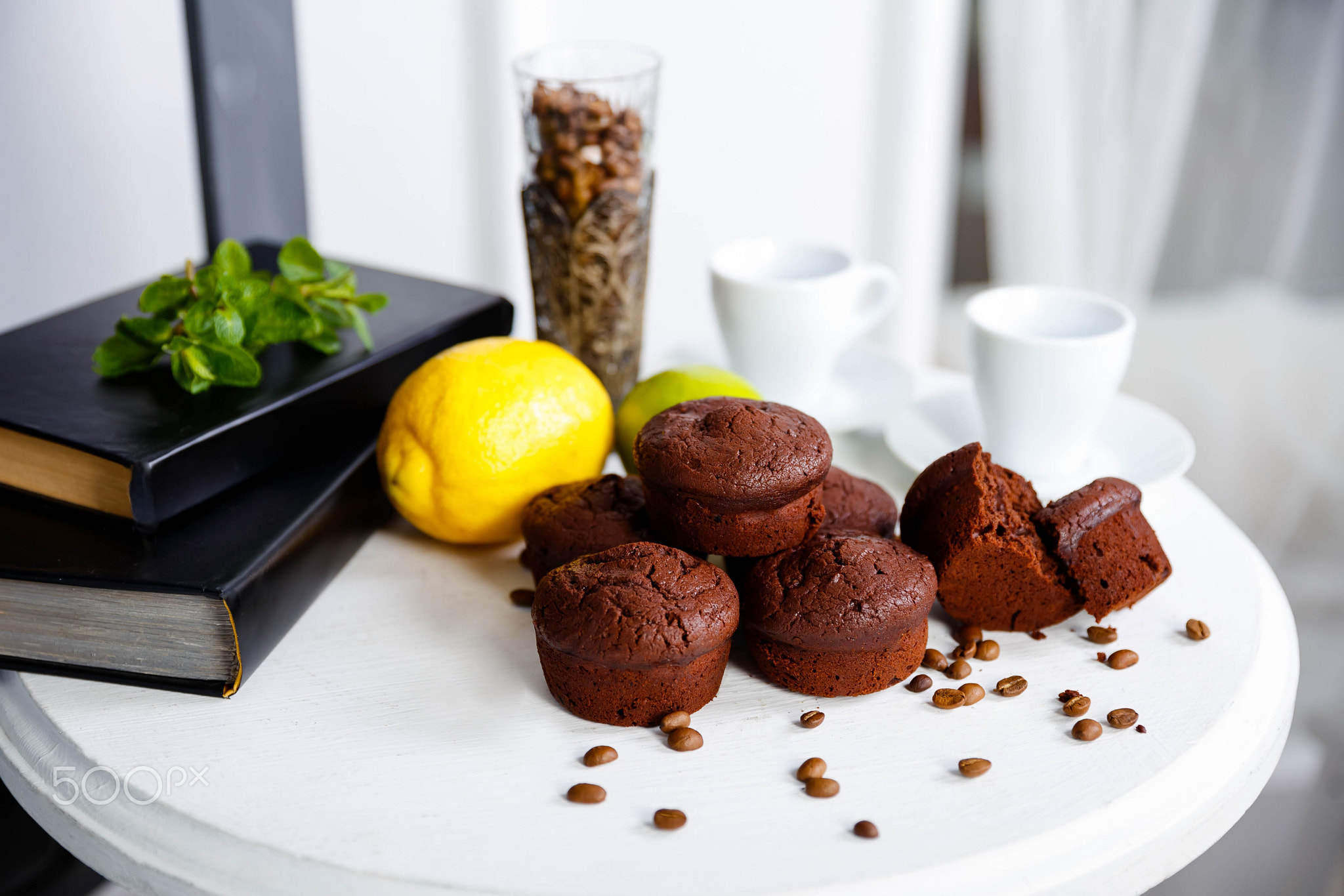 Chocolate cupcakes with coffee beans on a white wooden table