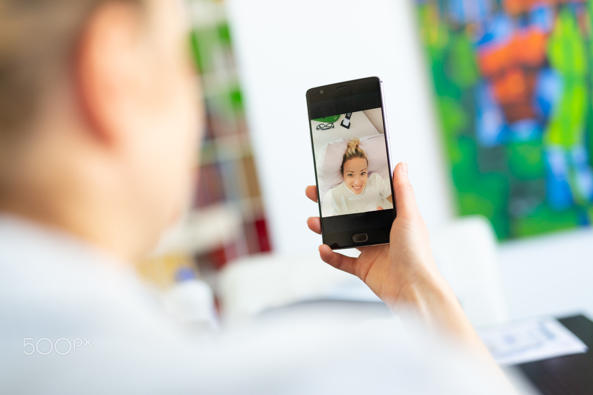 Woman at home using social media on phone for video chatting with her