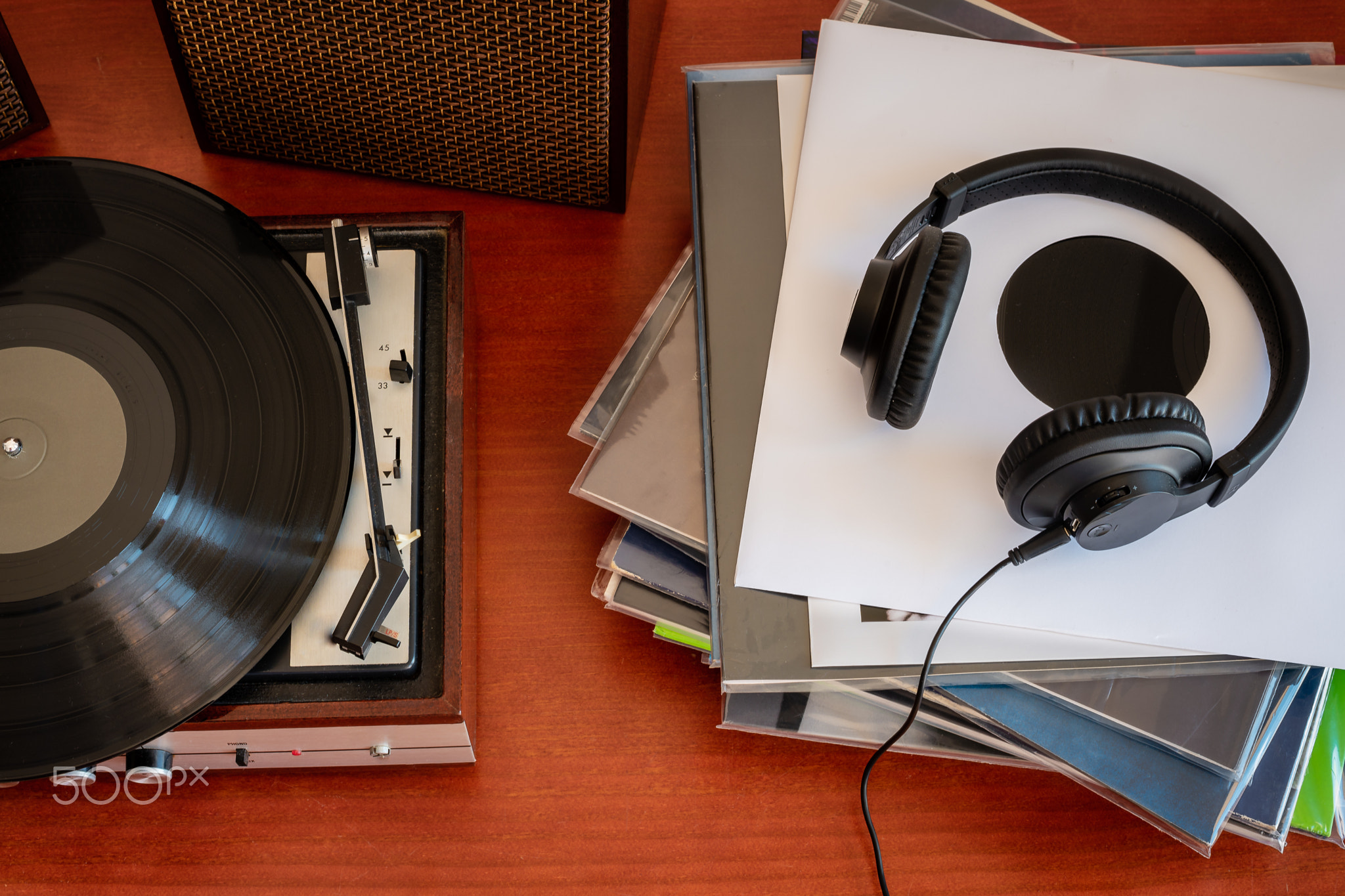 Vintage turntable with vinyls and headphones on a table