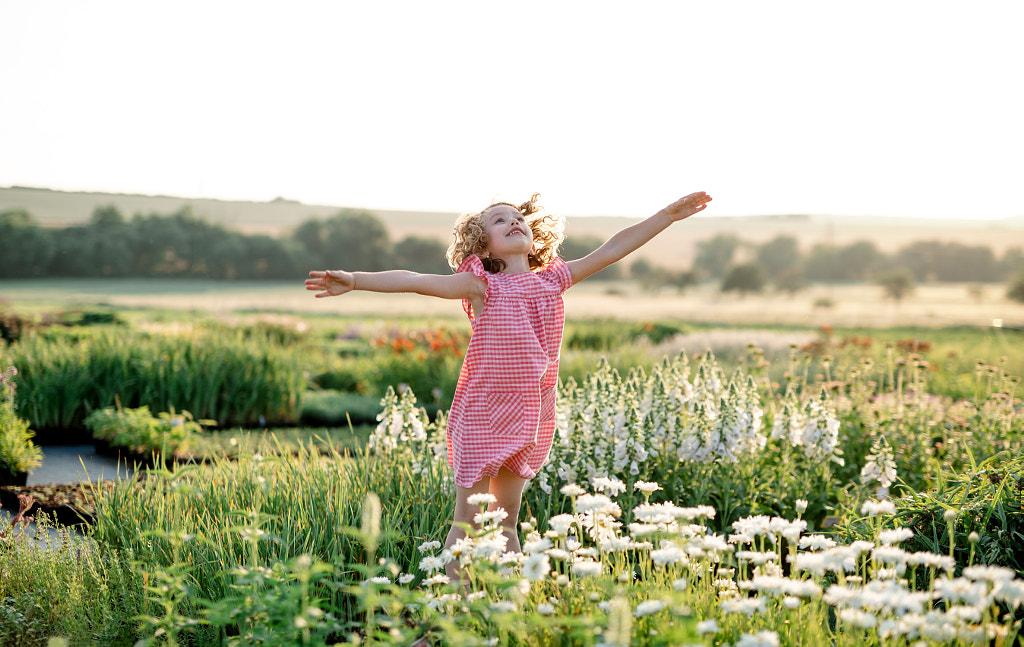 Cheerful small girl running in the backyard garden, having fun. by Jozef Polc on 500px.com