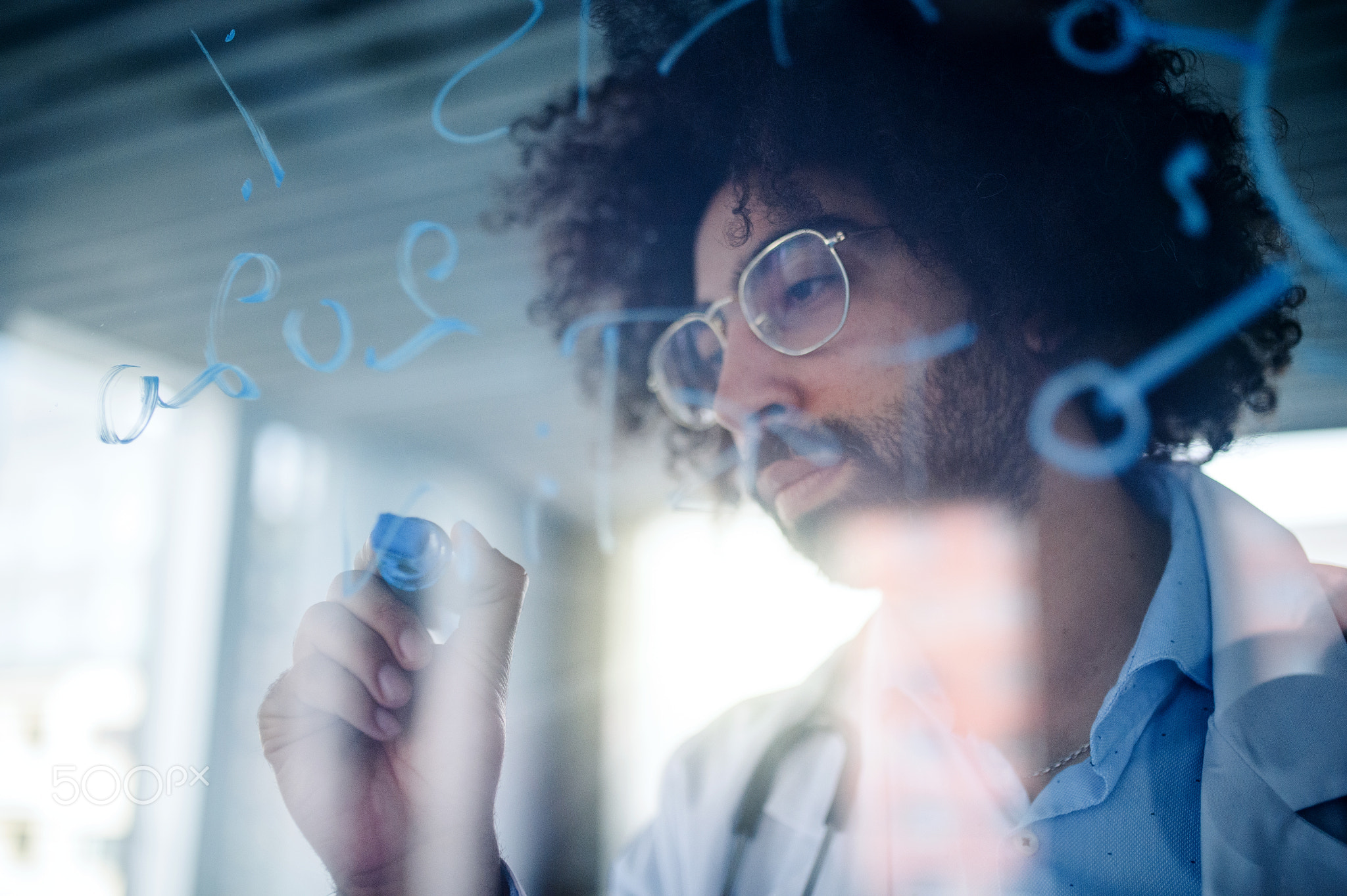 Doctor making notes in hospital, corona virus concept. Shot through