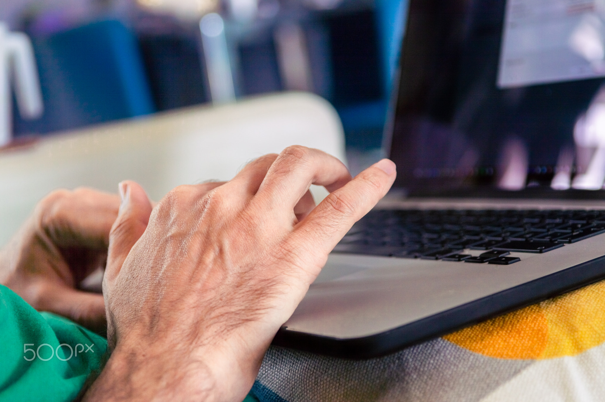 Man working on laptop on a cozy couch at home