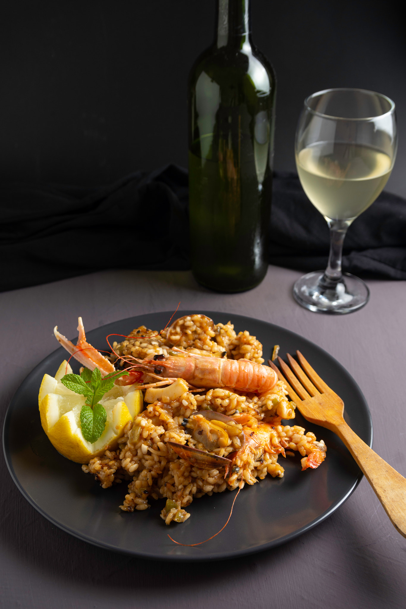 Spanish seafood paella on black plate