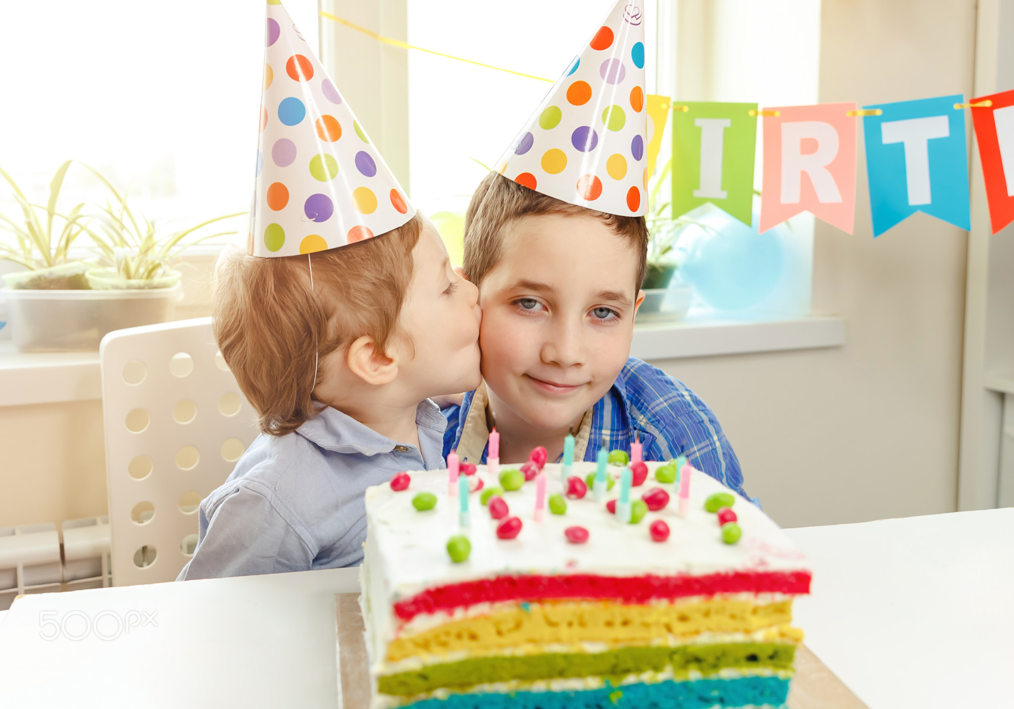 A cute boy wishes his brother a happy birthday. Family celebration