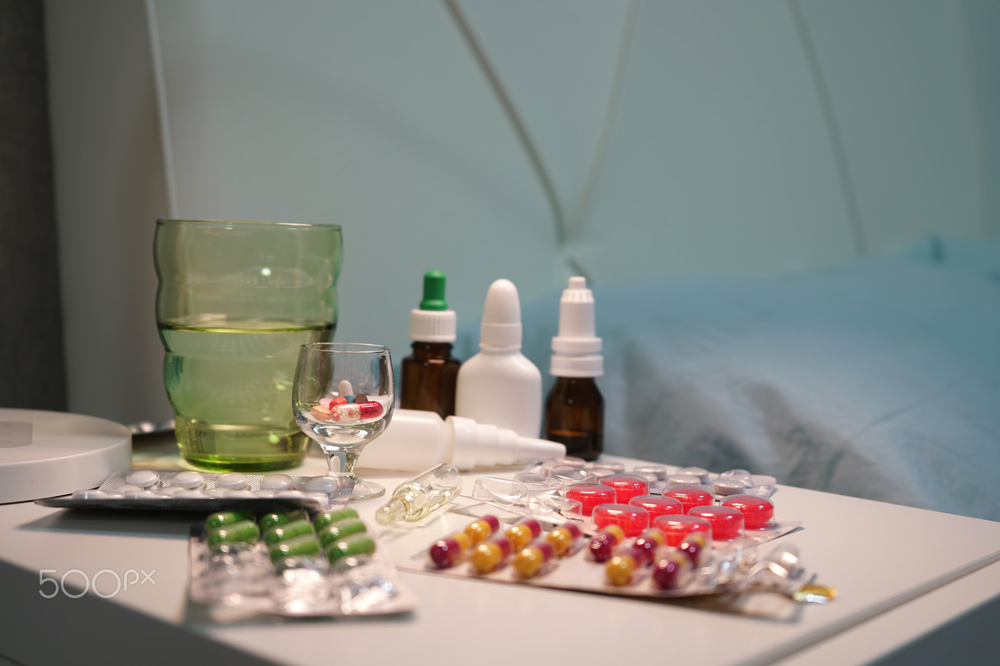 Close-up photo of tablets and capsules lying on the table next to the