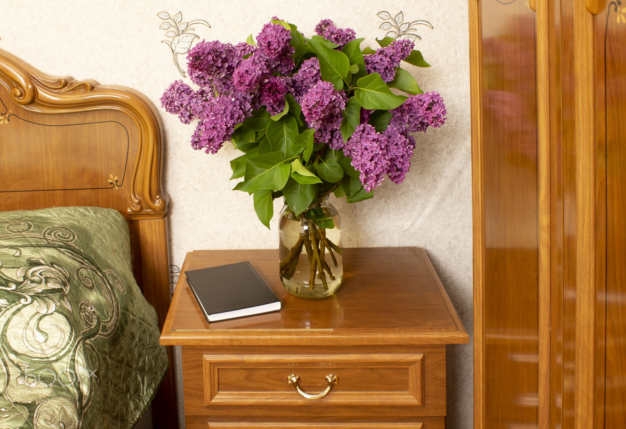 bouquet of serenis in a jar and a book on the bollard