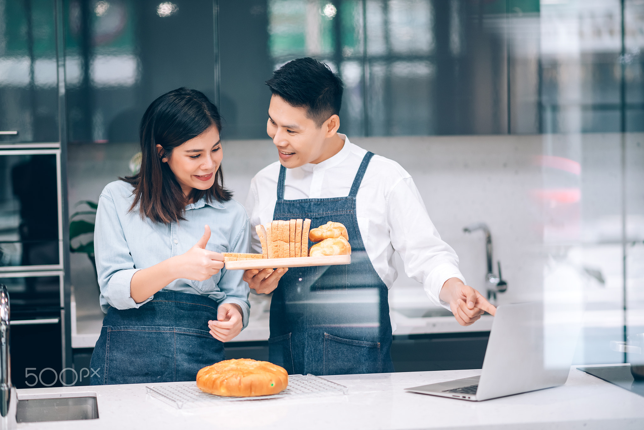 Asian Couple Preparing Homemade Bakery in the Kitchen at Home