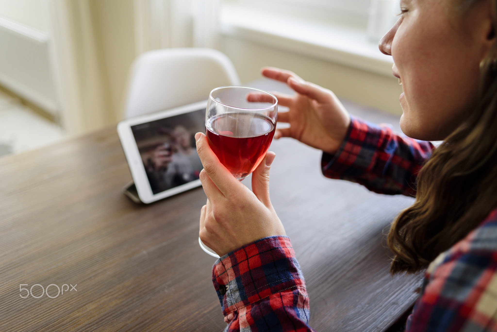 Woman drinking wine online with male friend