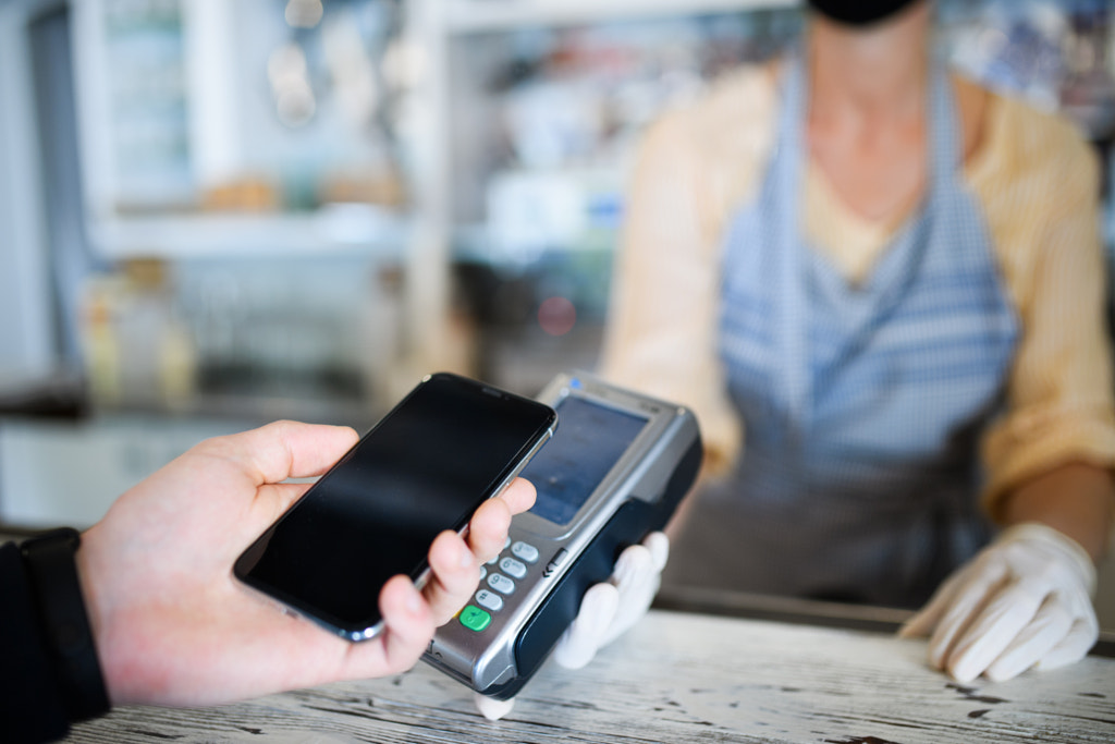 Contactless payment with smartphone, coffee shop open after lockdown. by Jozef Polc on 500px.com