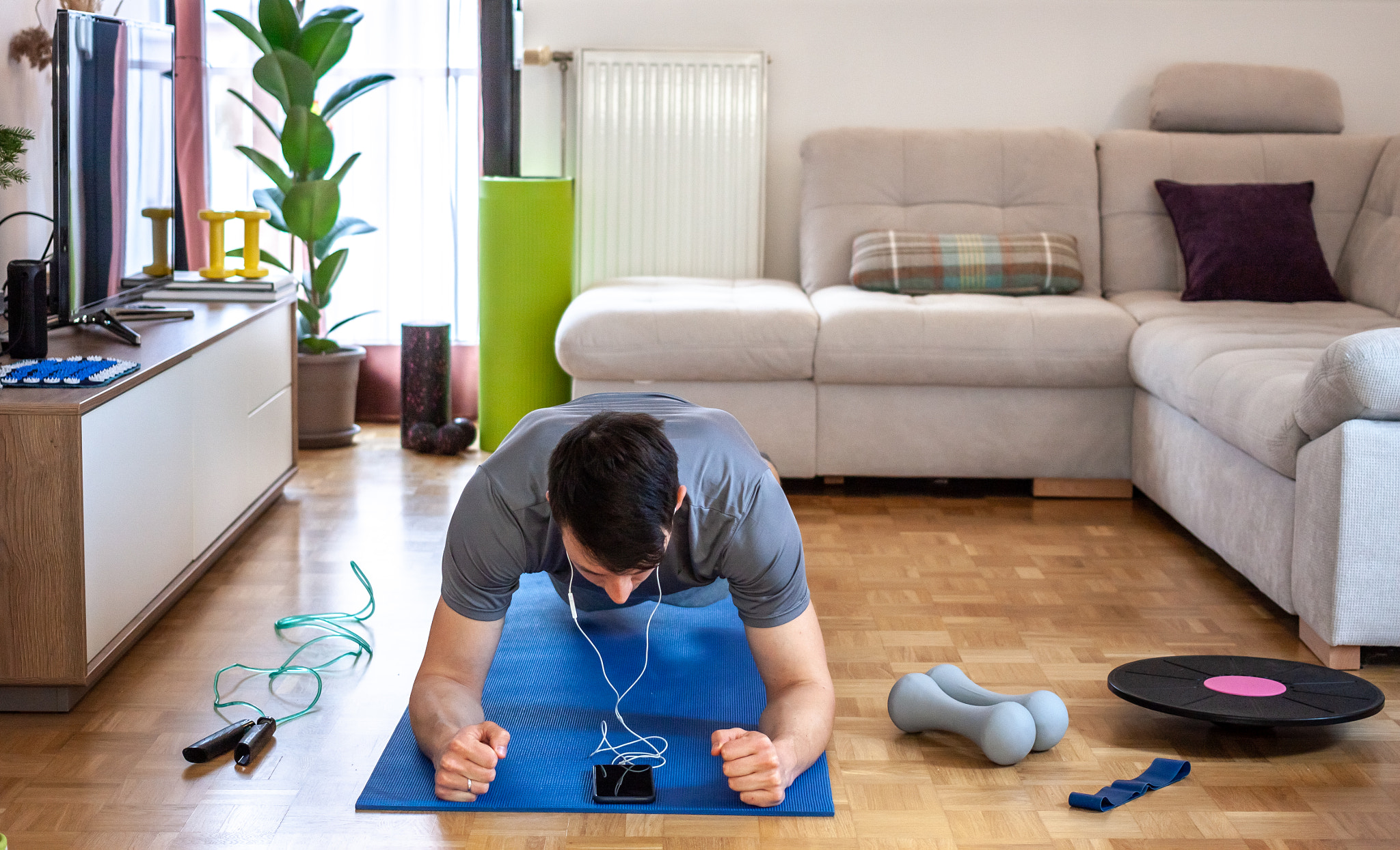 young man exercising doing workout at home