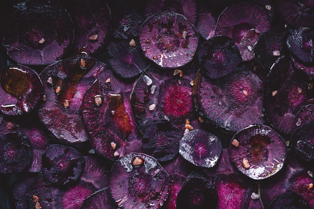 Slices of purple carrot with pink salt and olive oil for roasting by Edalin Photography on 500px.com