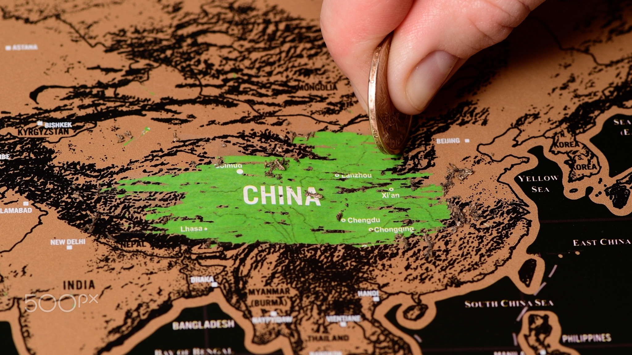 one dollar coin on black scratch travel map of China, Beijing