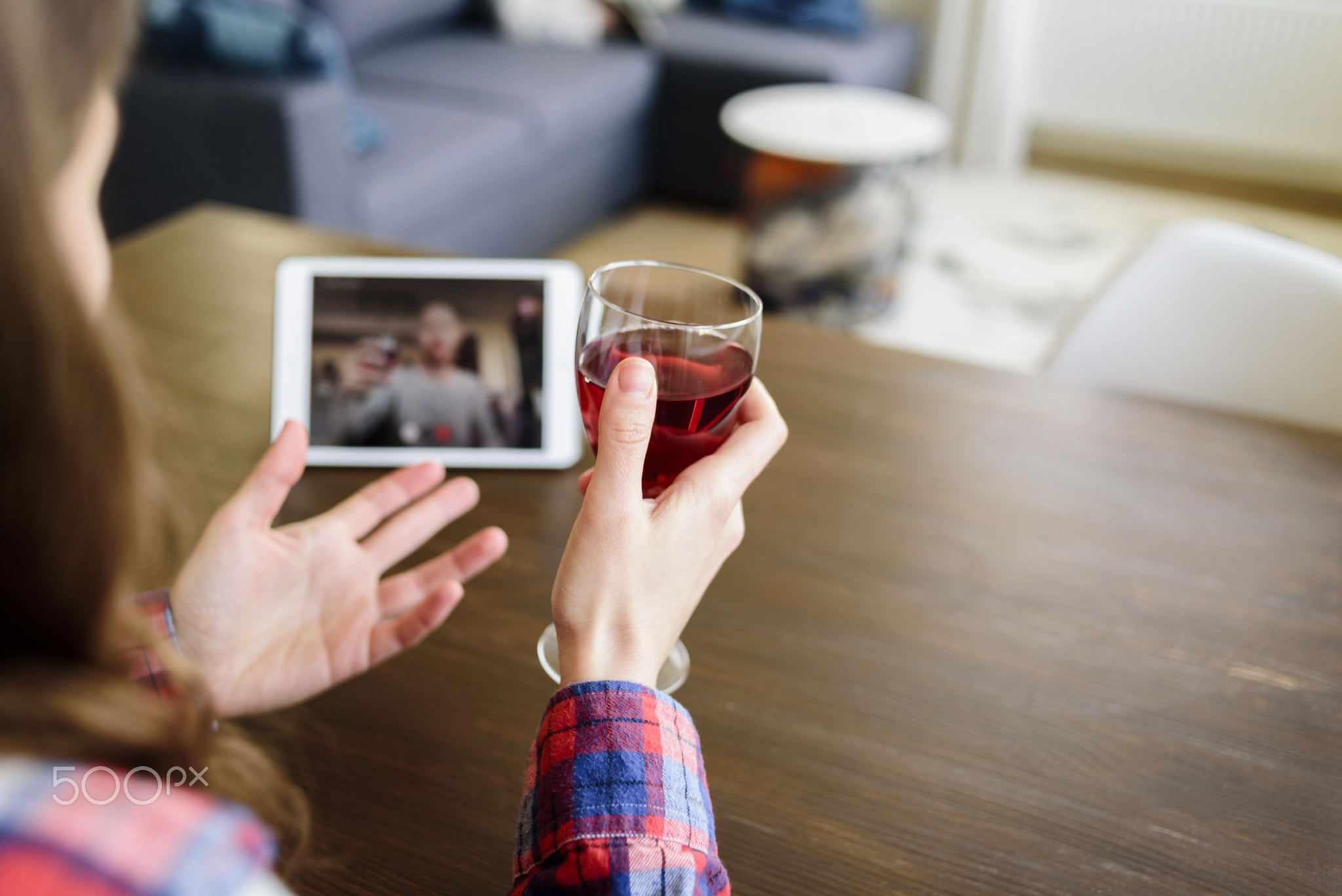 Woman drinking wine online with male friend