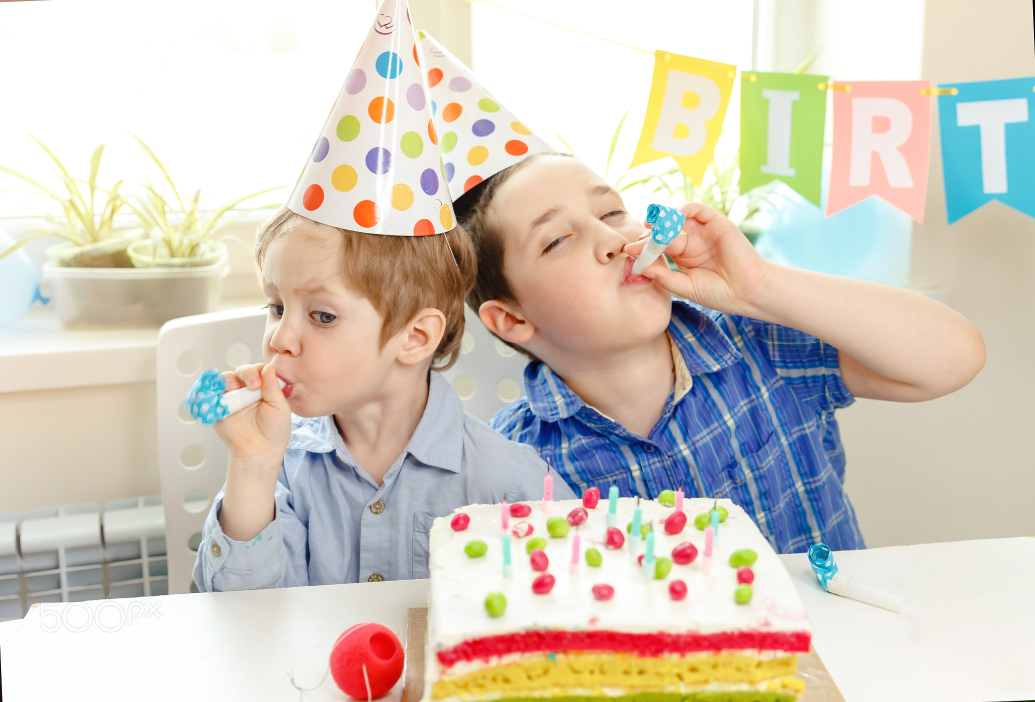 Happy boys celebrating a birthday together at home. Birthday party