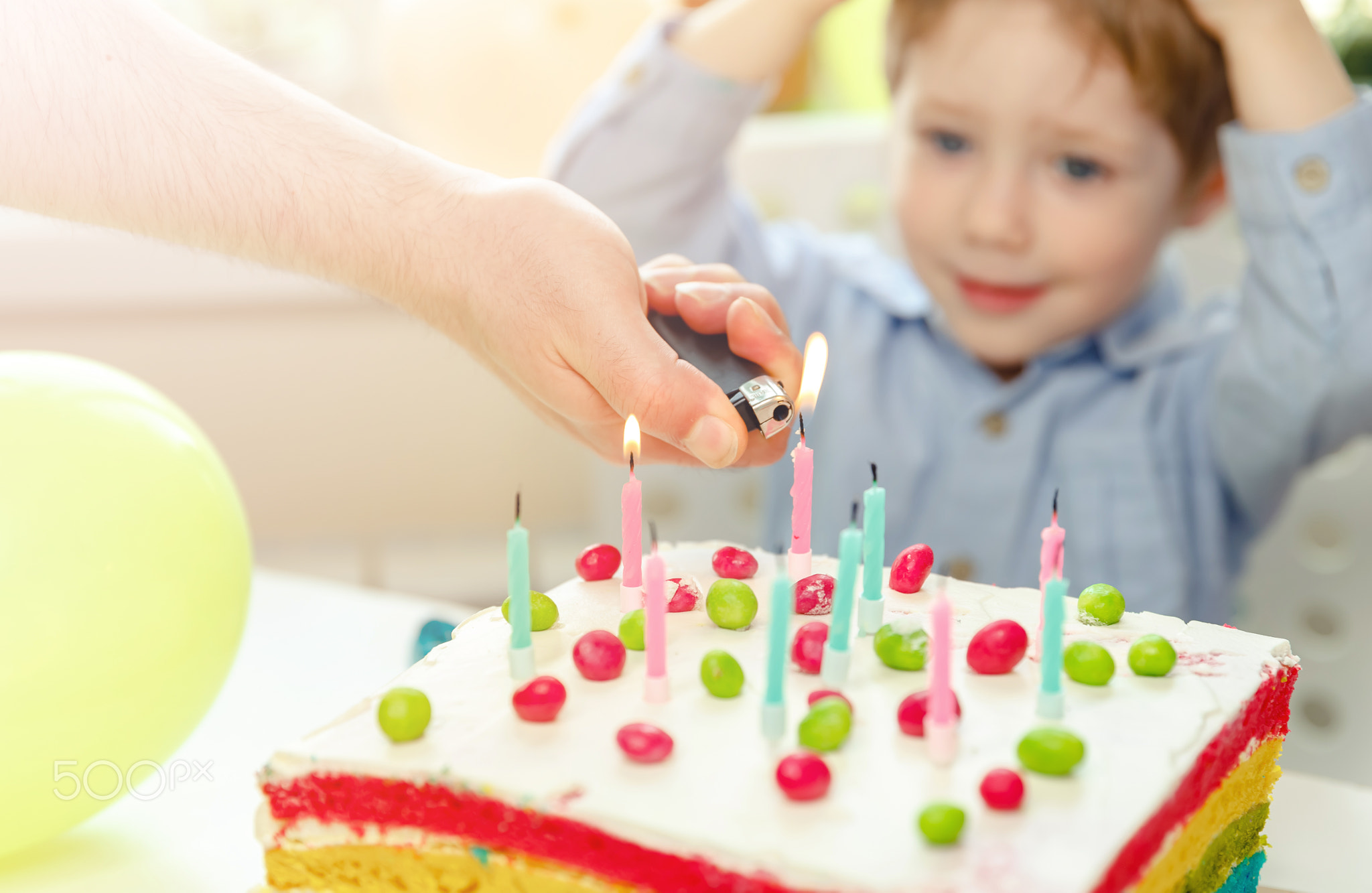 Little boy celebrating birthday. Child blowing out candles on cake