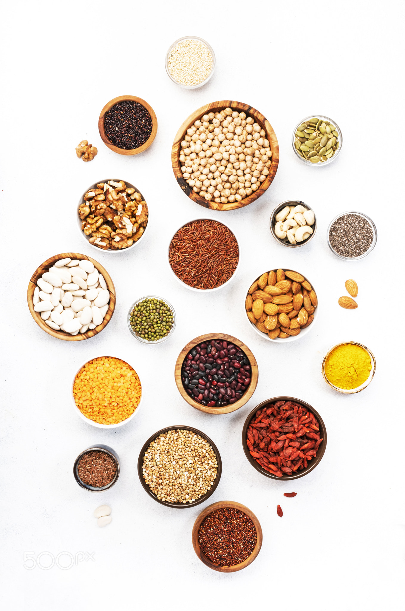 Various superfoods, legumes, cereals, nuts, seeds in bowls