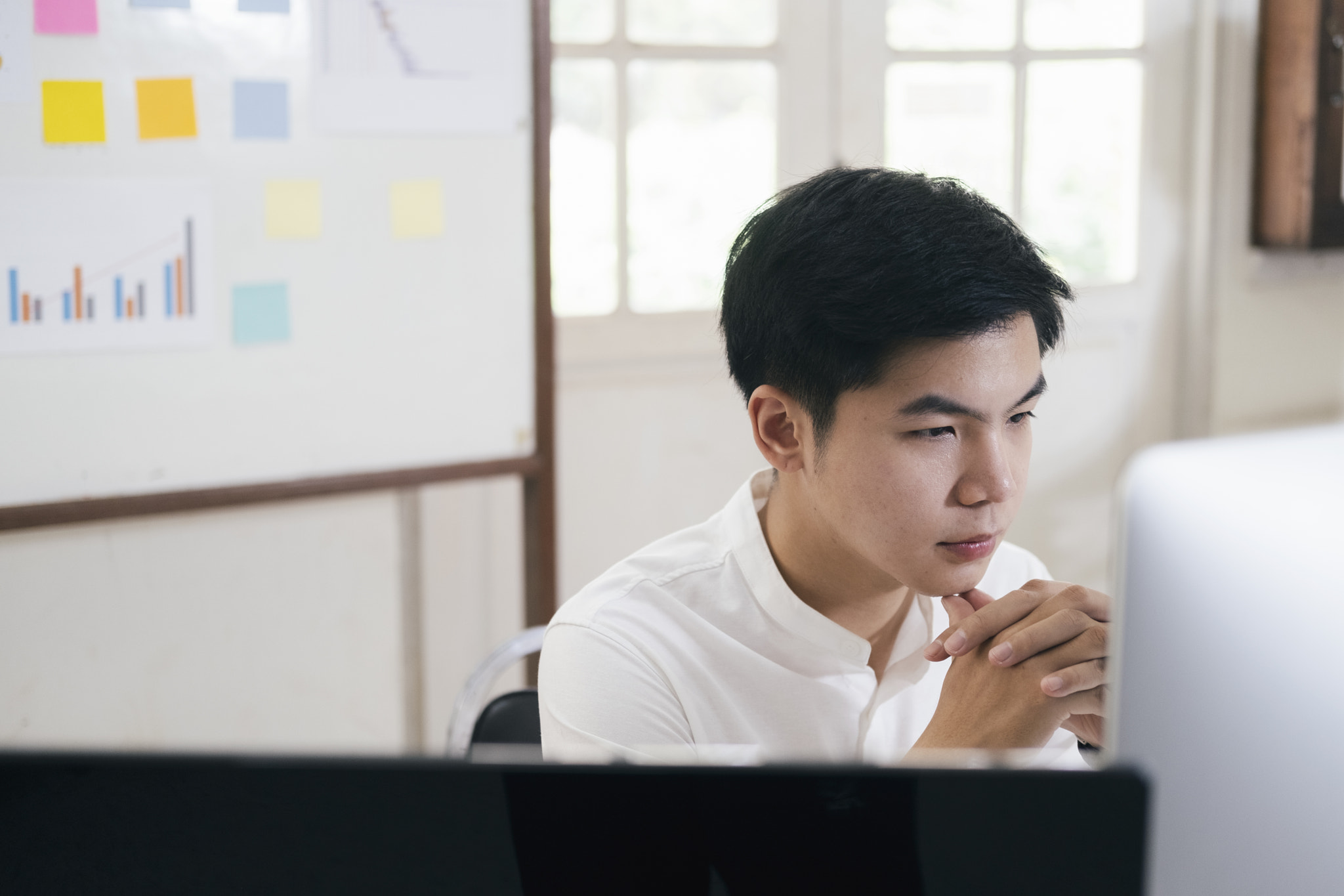 Young businessman analyze online marketing in his computer