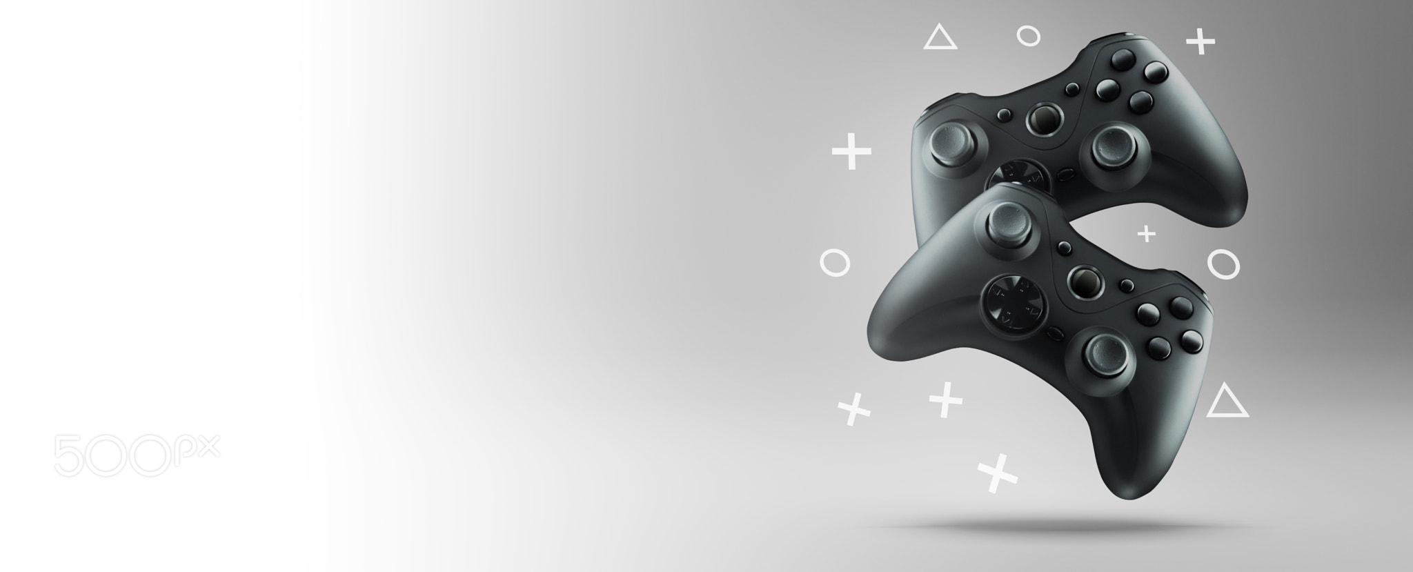 Two gamepads on a light background.