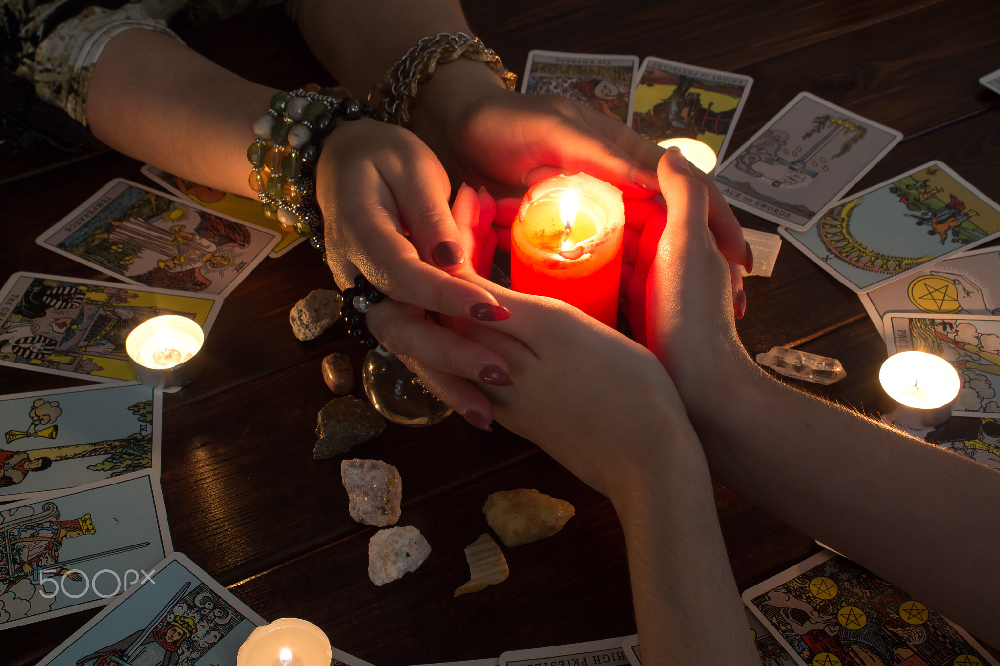 Female hands hold a lighted candle