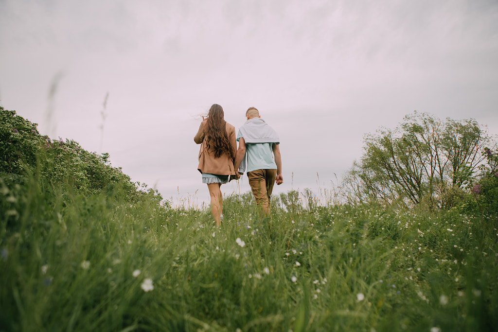 young couple holding hands on a walk by Alena Sadreeva on 500px.com