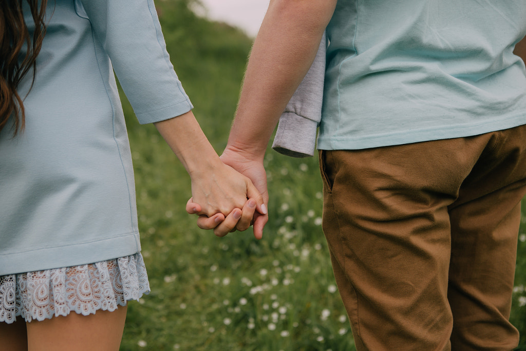 Two adult hands intertwined against a solid background by Alena Sadreeva on 500px.com