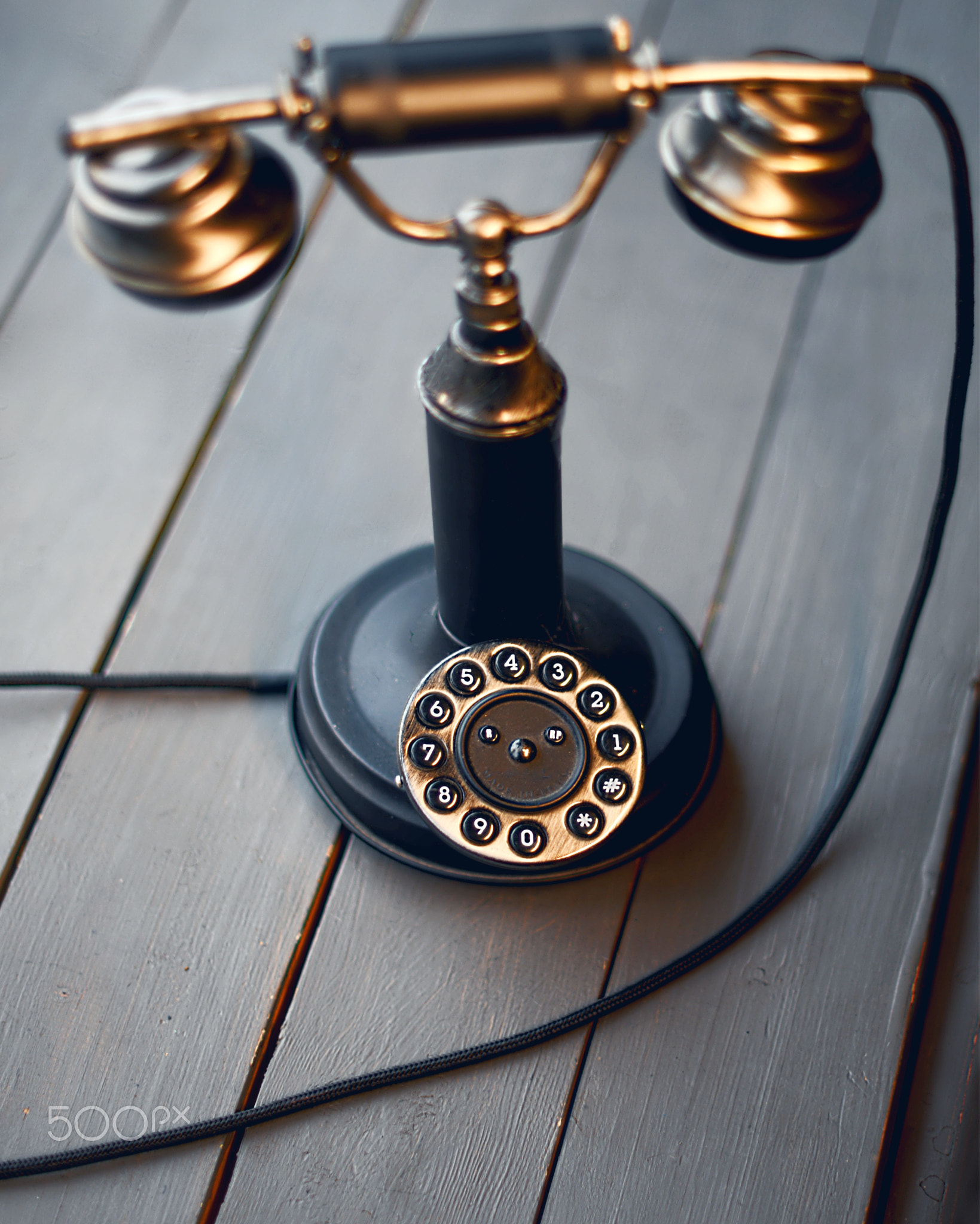 Old telephone on wooden background. Copy space