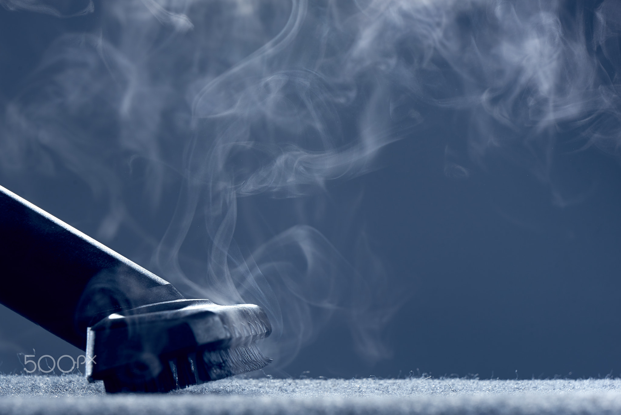 Steam close-up. Steam carpet cleaning on grey background. Home