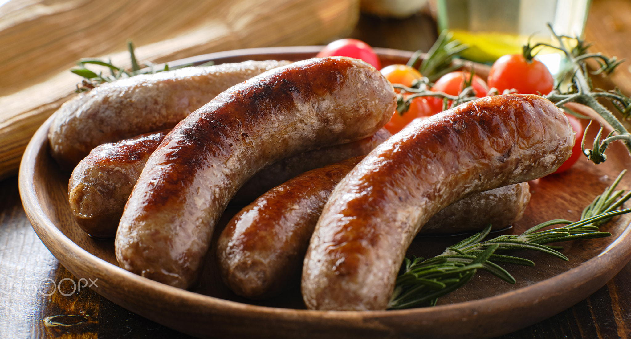 plate of german bratwurst sausages with herbs