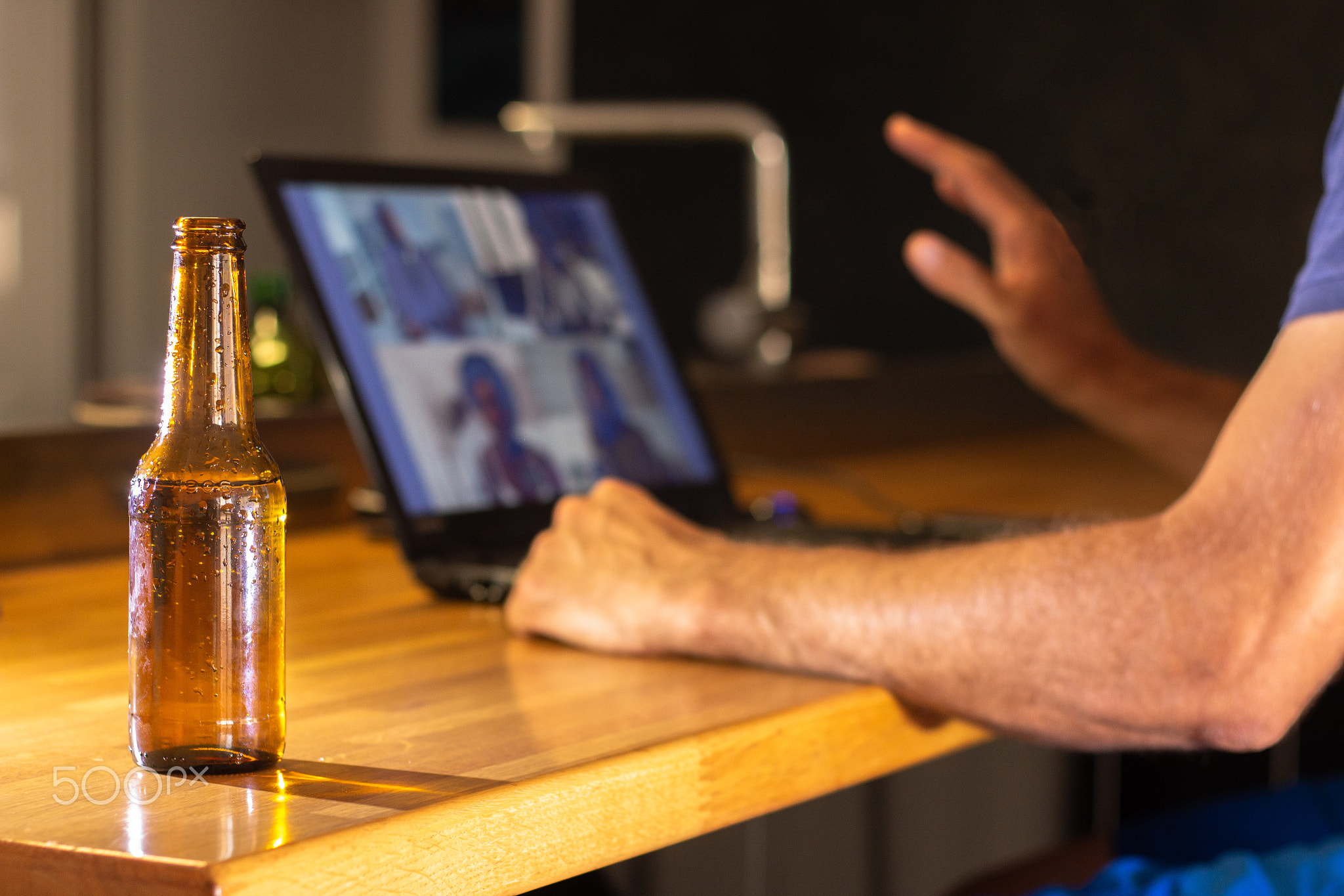 Video call with several friends from home while having a beer