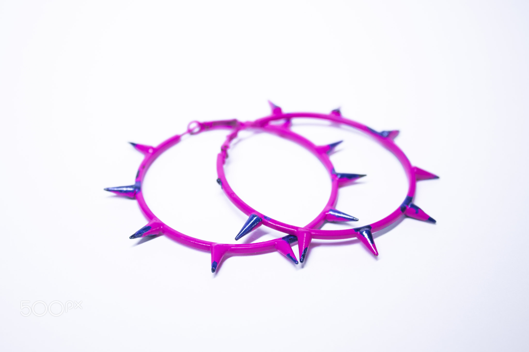 Pink and blue earrings with spikes. jewelry and accessories concept