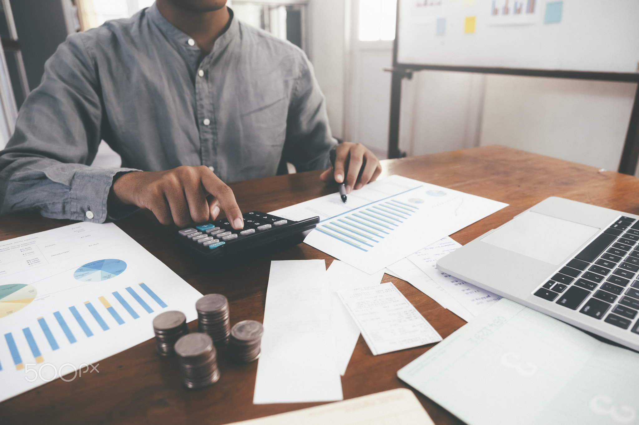 Closeup accountant using calculator.