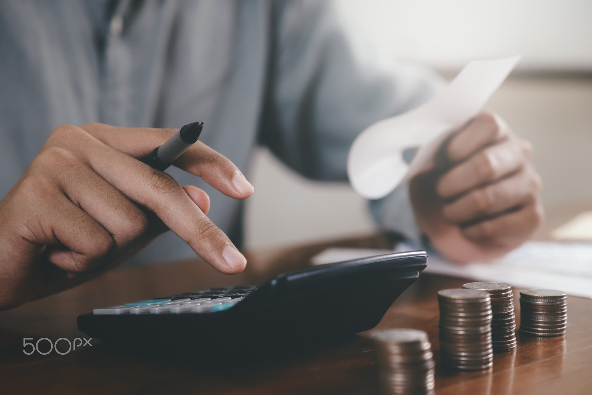 Closeup accountant using calculator.