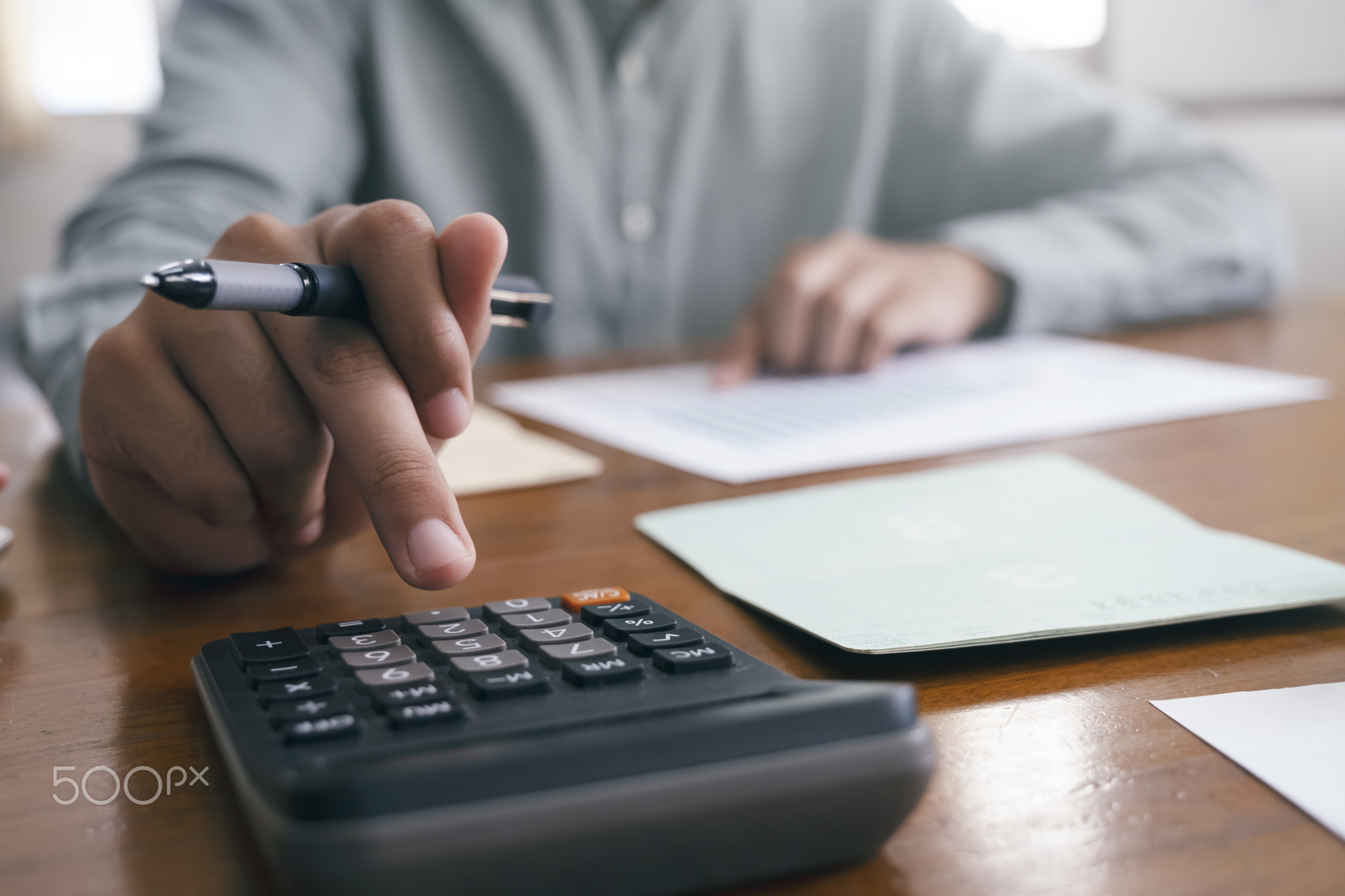 Closeup accountant using calculator.