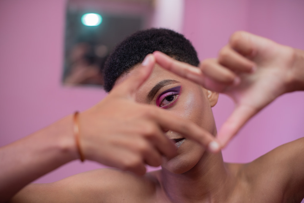 Portrait of young queer male watching through his fingers by Rushay  Booysen on 500px.com