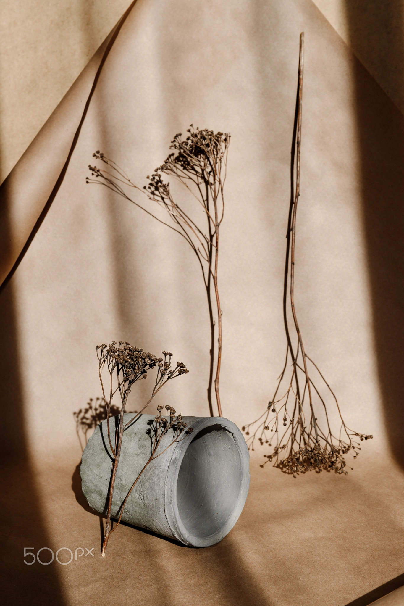 Abstract creative minimal composition with a clay pot and dry grass