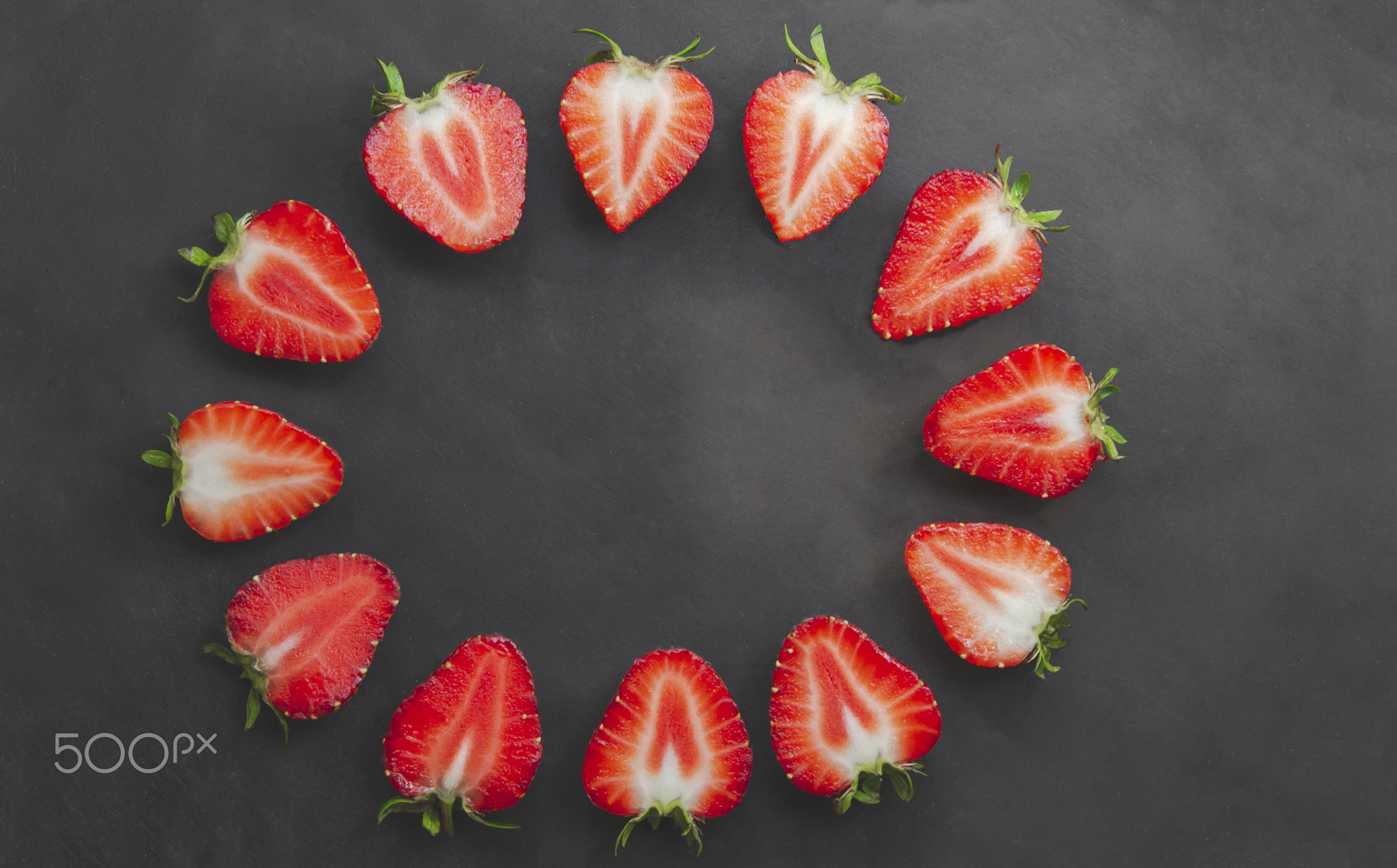 Close up picture of sliced strawberries on black background