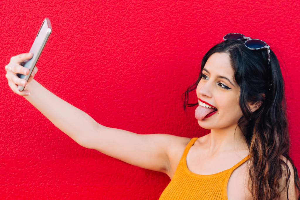 Portrait Of A Happy Young Woman Taking Selfie by Lorenzo López on 500px.com