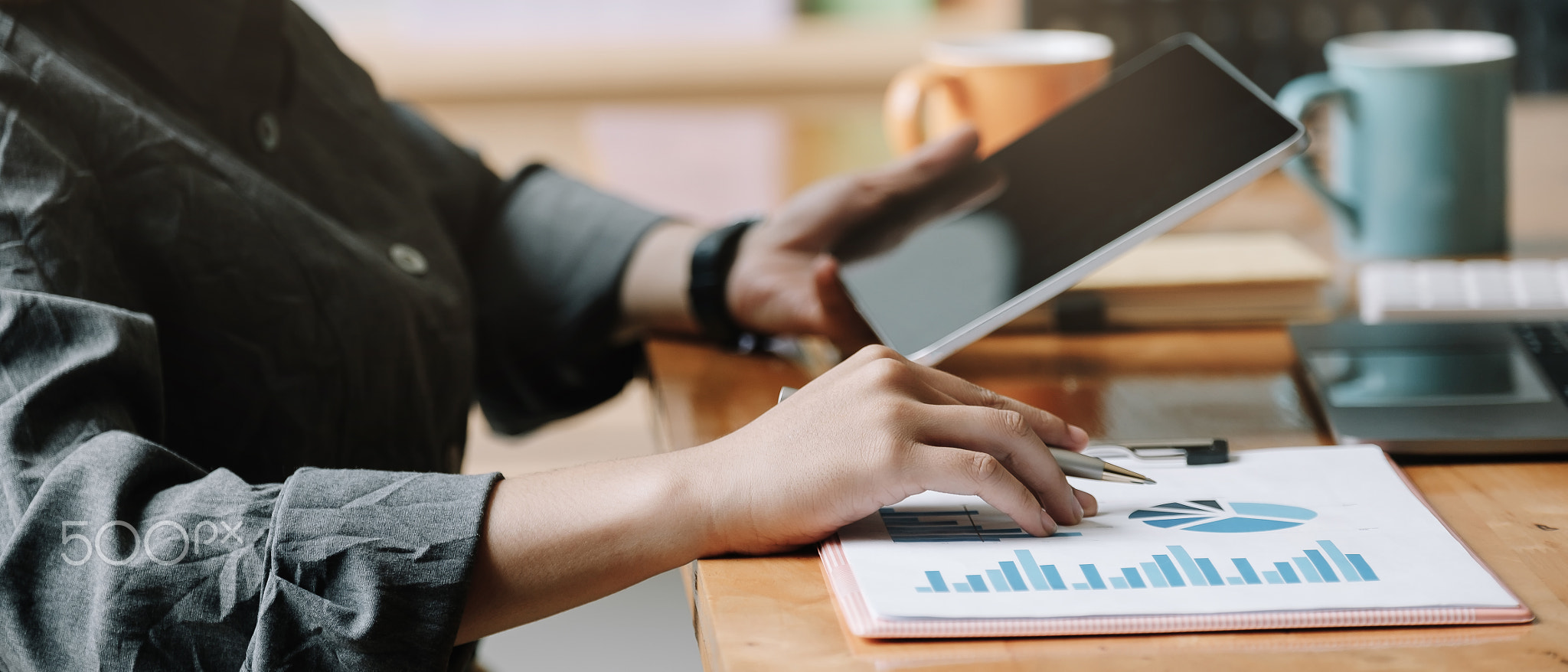 Business woman analysis financial report with tablet computer.