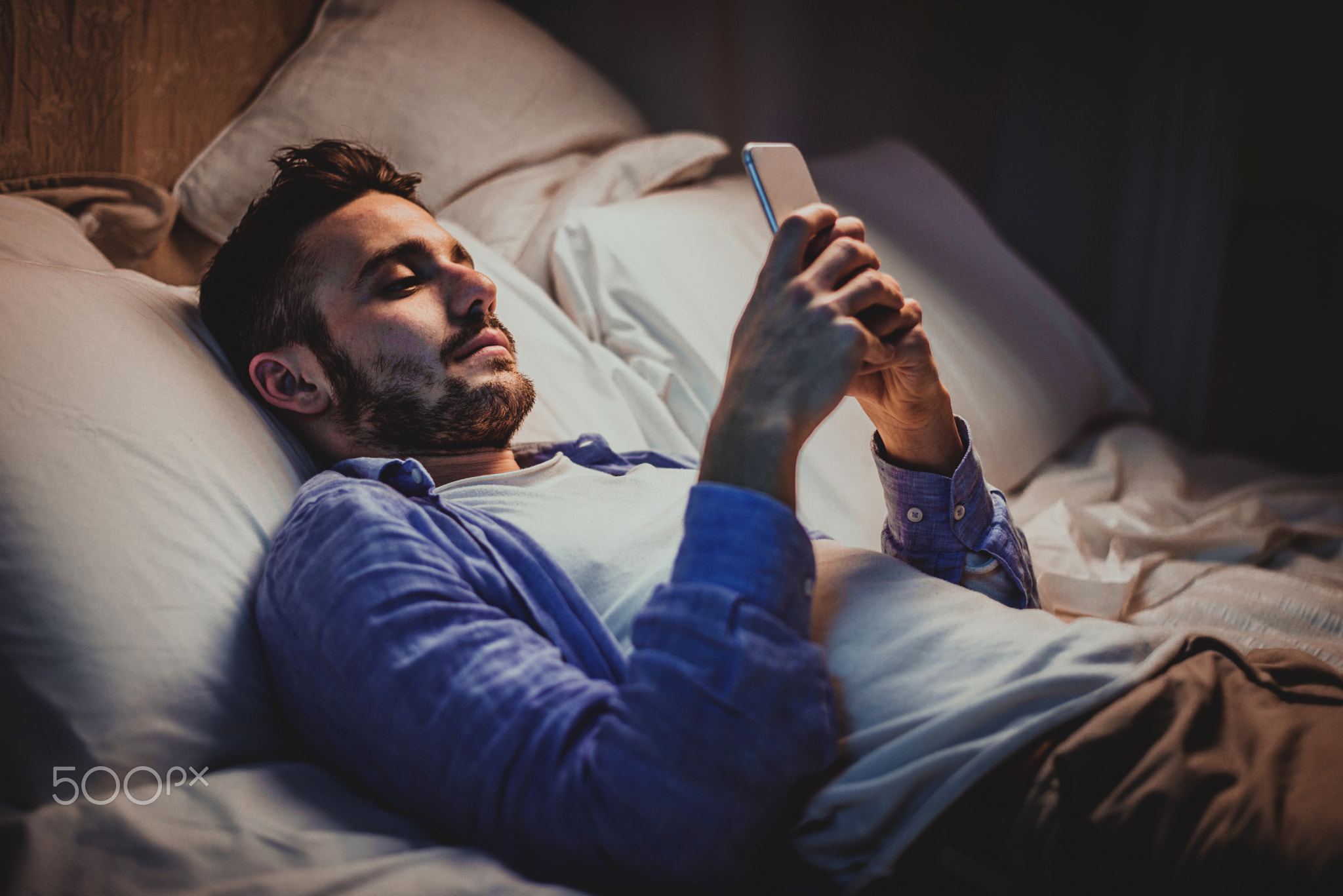 Young adult using smartphone at home