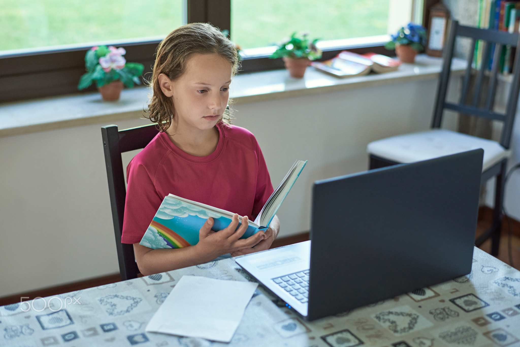 Girl remote studing online at home infront of the laptop
